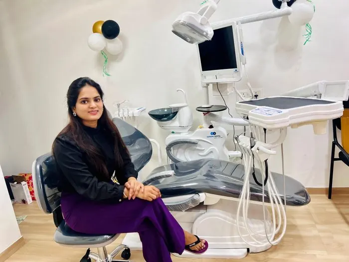 Dr. Pooja Biradar-Motagi seated beside a dental chair in a treatment room at Ekdant Dental Clinic